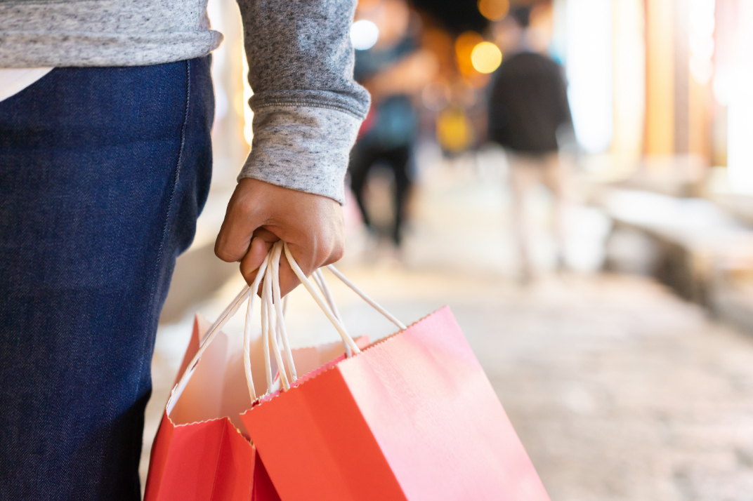 shopper holding shopping bags