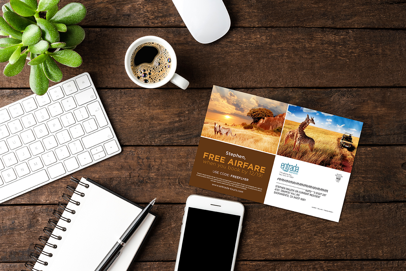 notepad, phone and keyboard on a desk with direct mail