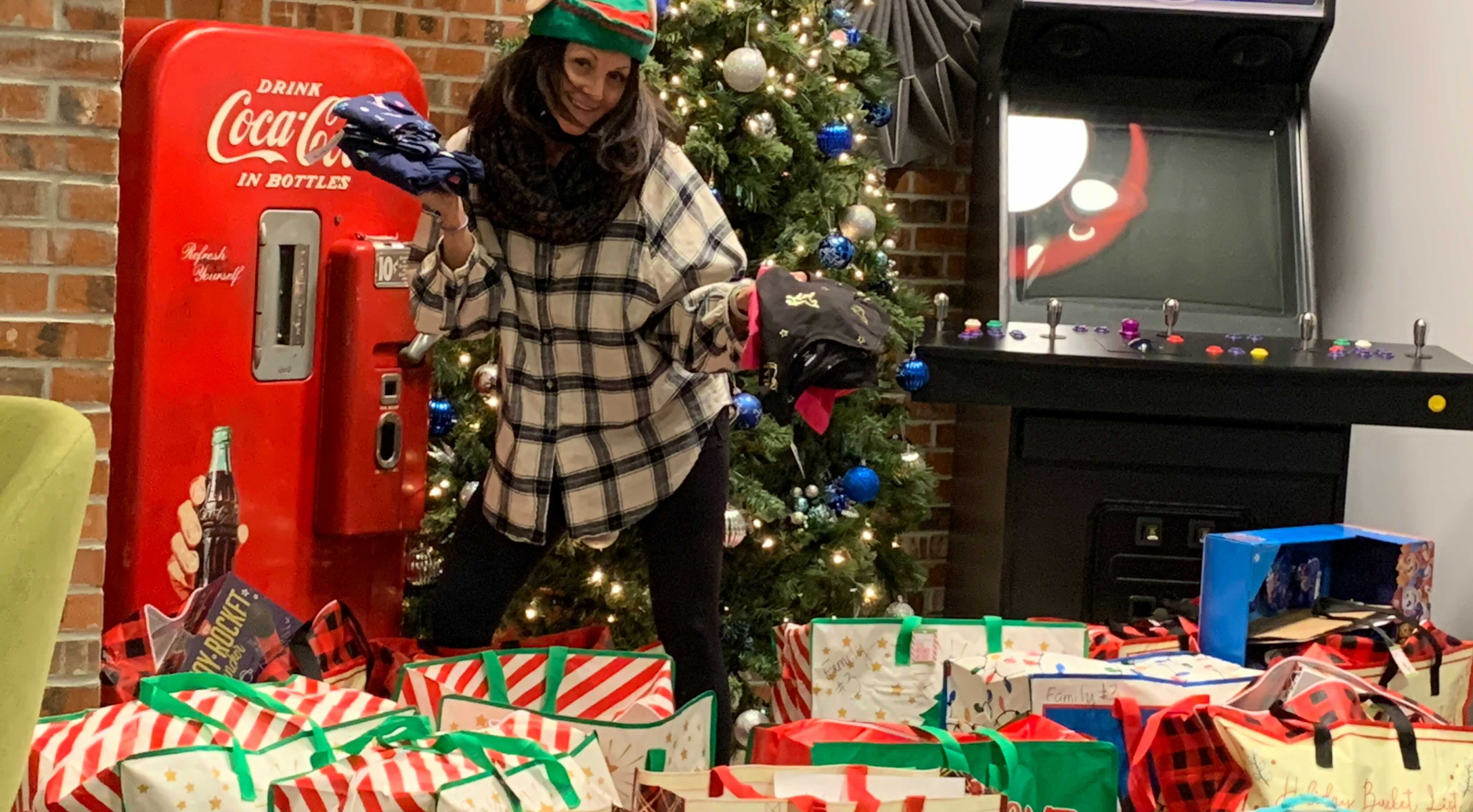 joyous woman celebrating christmas at home with gifts