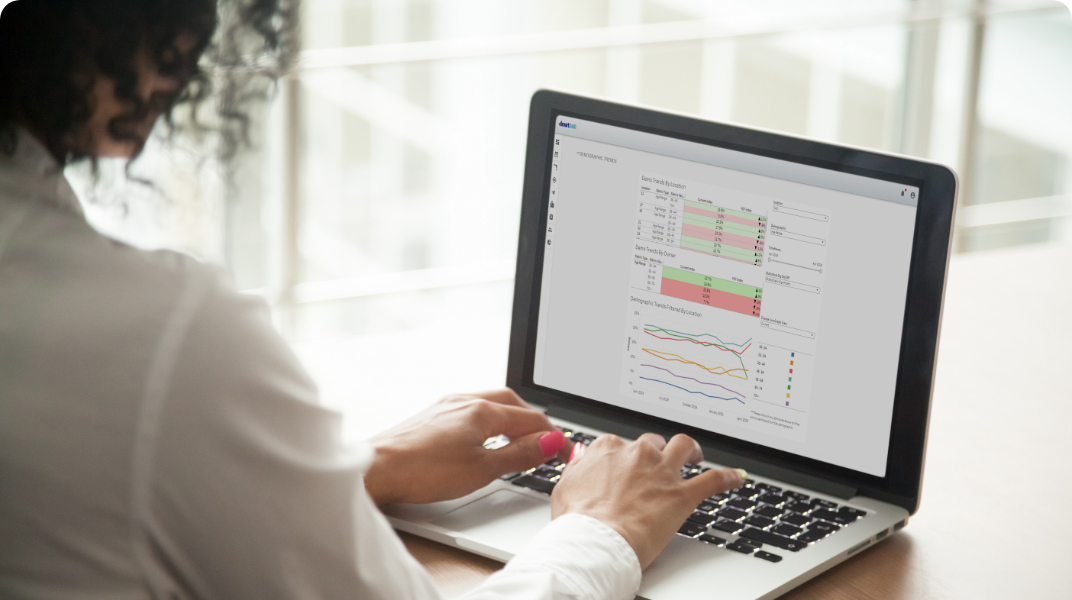 woman looking at a month end report on her laptop