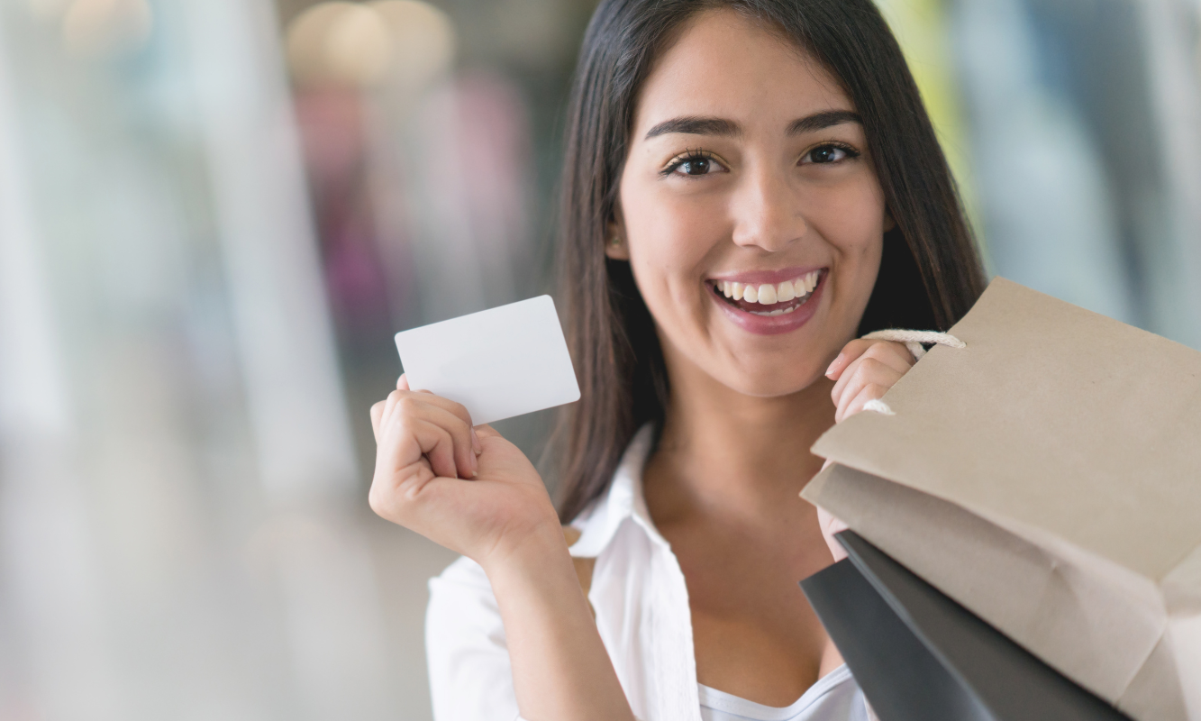 woman smiling holding a business card