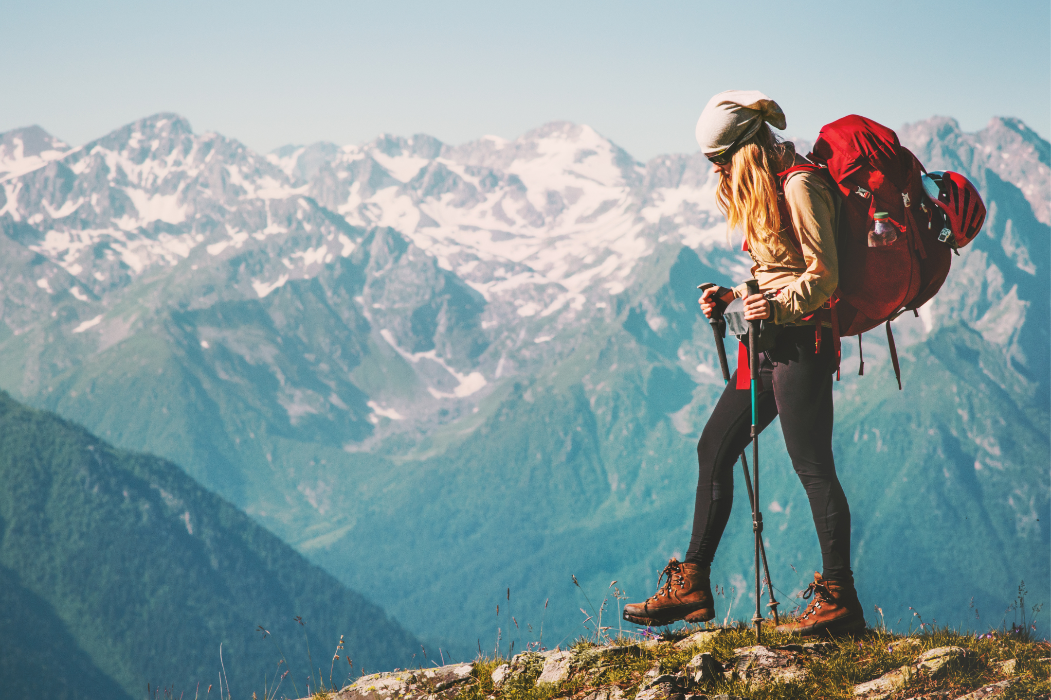 hiker climbing to the top of a mountain