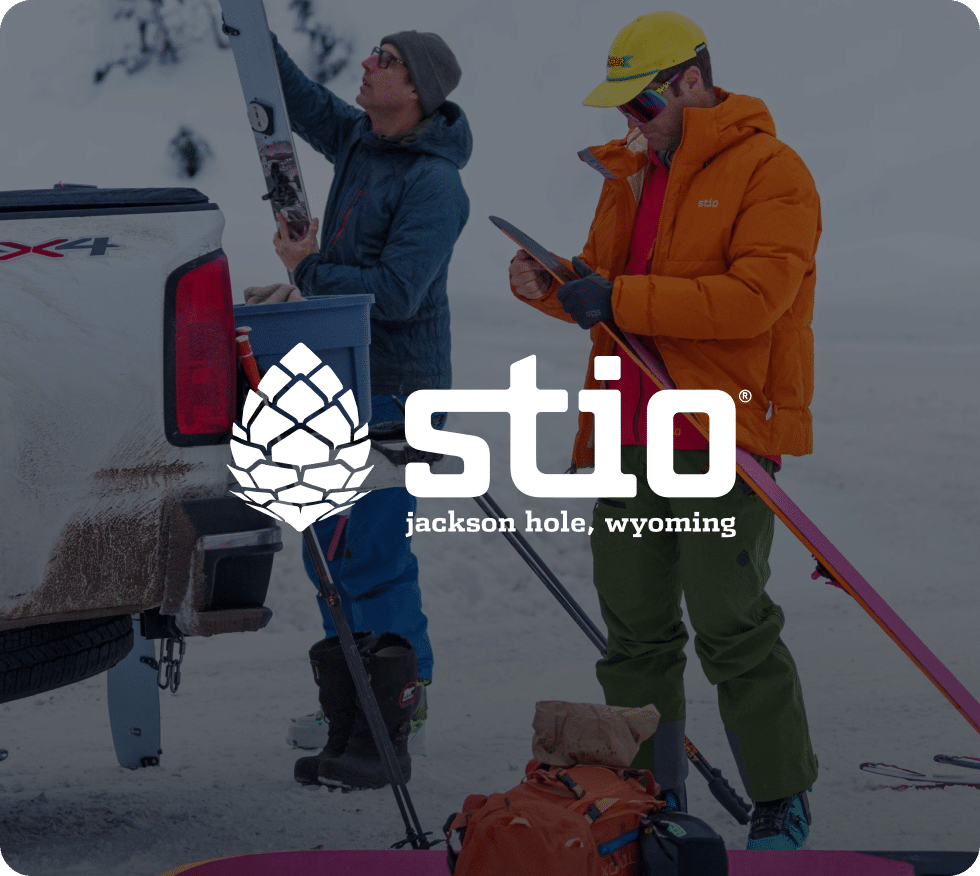 Stio brand image with people holding ski equipment