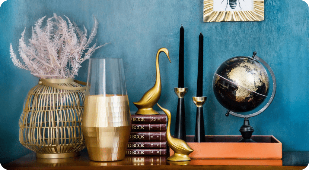 Home decor items such as vases and a globe on a table