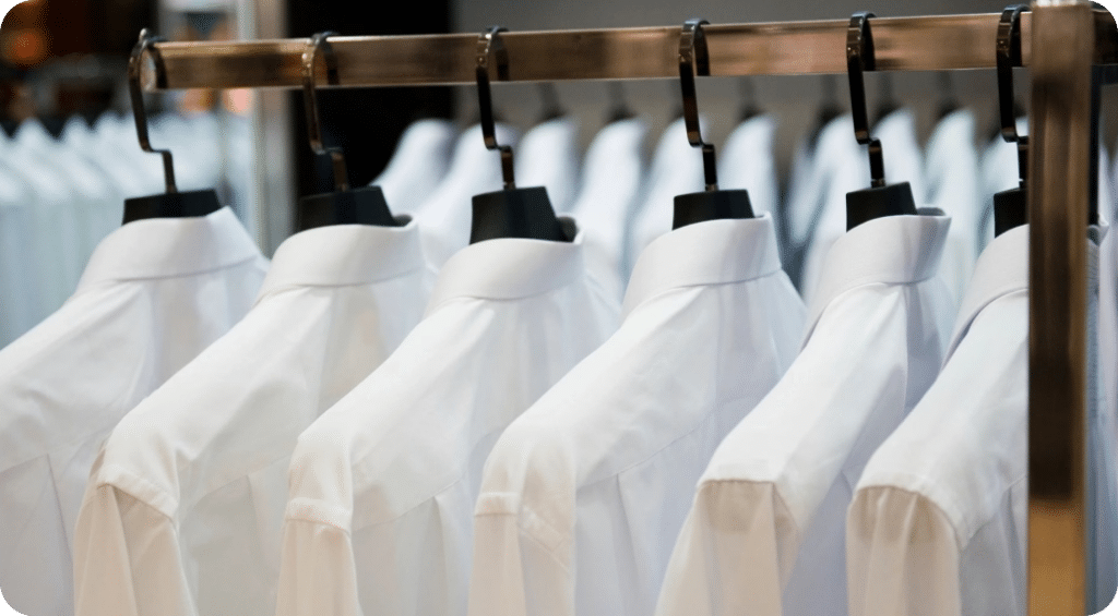 white dress shirts hanging on clothing rack