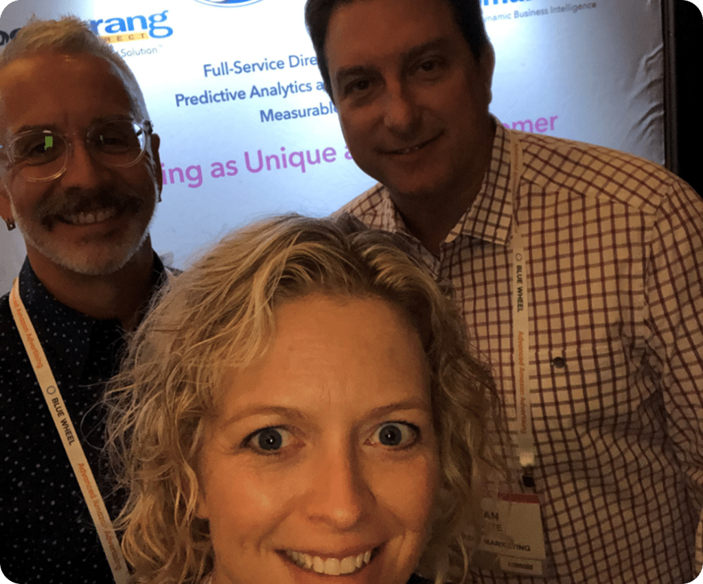 3 people with a boomerang plus backdrop